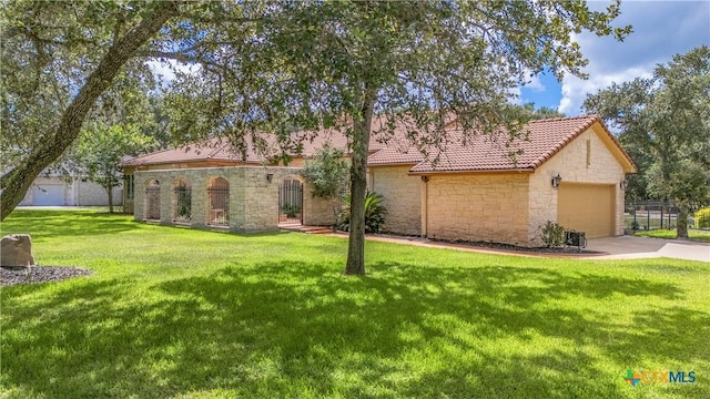 mediterranean / spanish home with stone siding, a tile roof, and a front yard