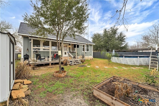 back of house featuring a pool side deck and a lawn