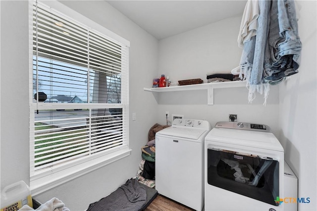 laundry room featuring hardwood / wood-style flooring and washer and clothes dryer