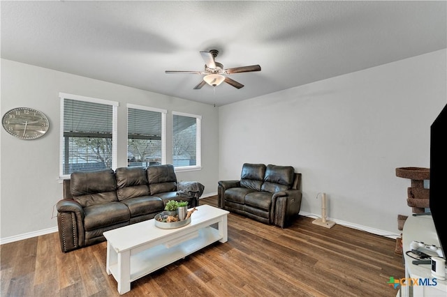 living room with ceiling fan and dark hardwood / wood-style flooring