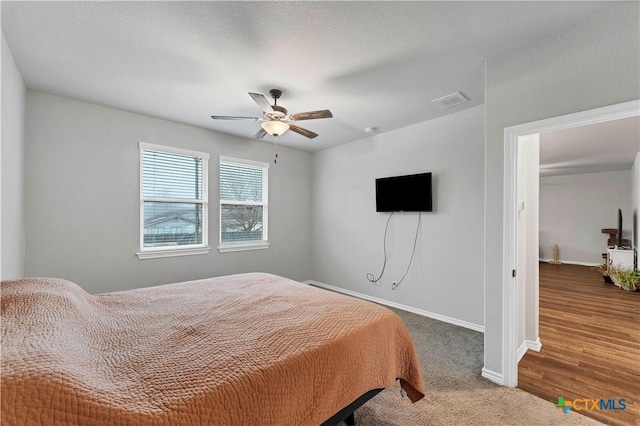 bedroom featuring ceiling fan and dark colored carpet