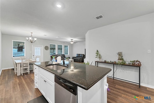 kitchen with sink, white cabinetry, stainless steel dishwasher, an island with sink, and dark stone counters