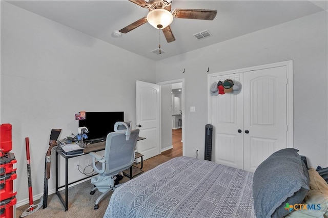 carpeted bedroom featuring ceiling fan and a closet