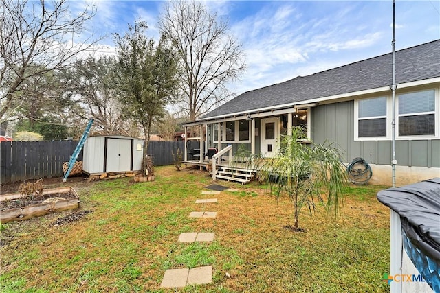 view of yard with a wooden deck and a storage unit