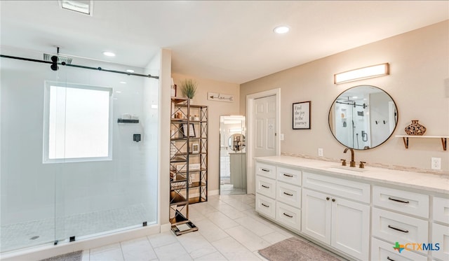 bathroom featuring vanity and a shower with shower door