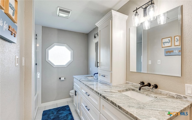 bathroom with tile patterned floors, vanity, and toilet