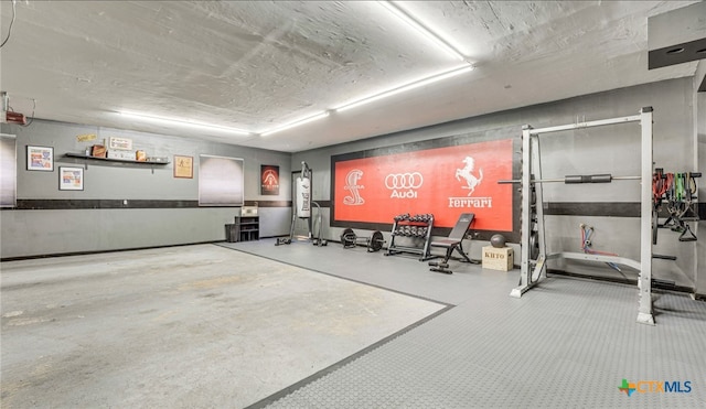 interior space featuring concrete flooring and water heater