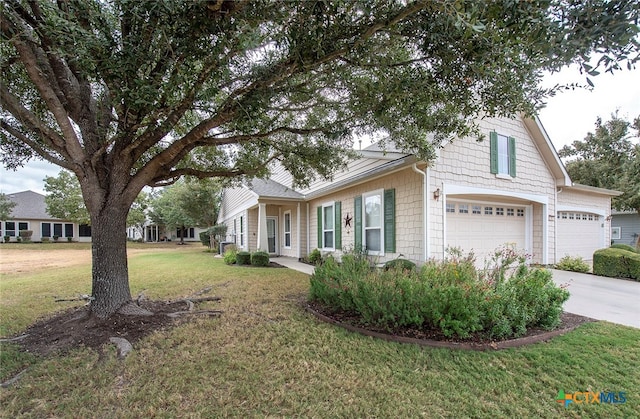 view of front of home with a garage and a front yard