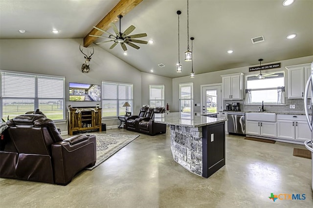 kitchen with decorative light fixtures, stainless steel dishwasher, a center island, and white cabinets