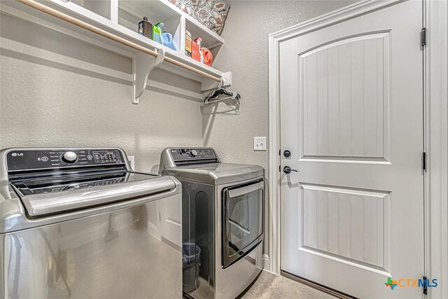 clothes washing area featuring independent washer and dryer