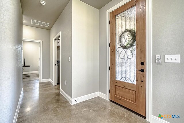 foyer entrance featuring concrete flooring