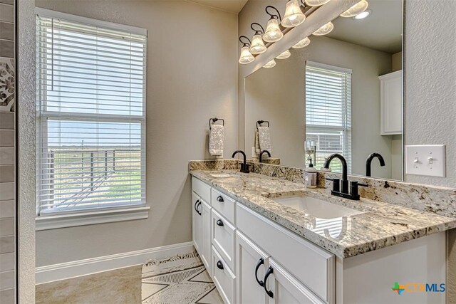 bathroom featuring vanity, a wealth of natural light, and tile patterned floors