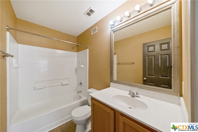 full bathroom featuring washtub / shower combination, vanity, toilet, and a textured ceiling