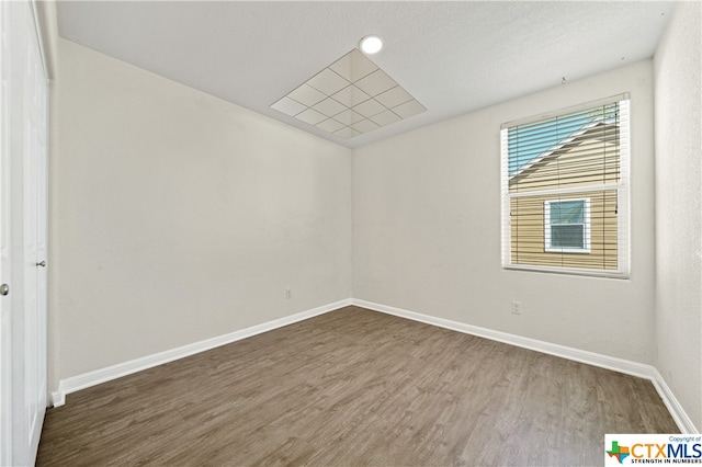 spare room with hardwood / wood-style floors