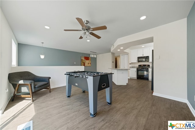 rec room featuring hardwood / wood-style floors and ceiling fan