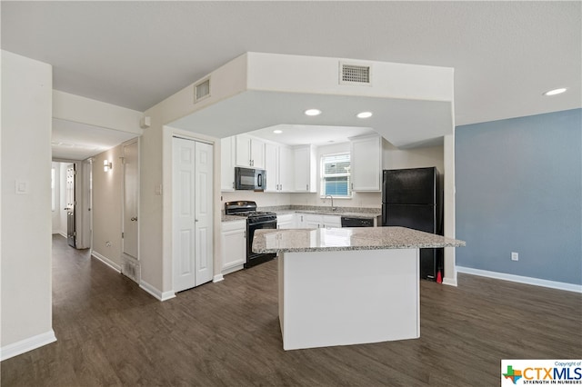 kitchen with black appliances, a kitchen island, dark wood-type flooring, and white cabinets