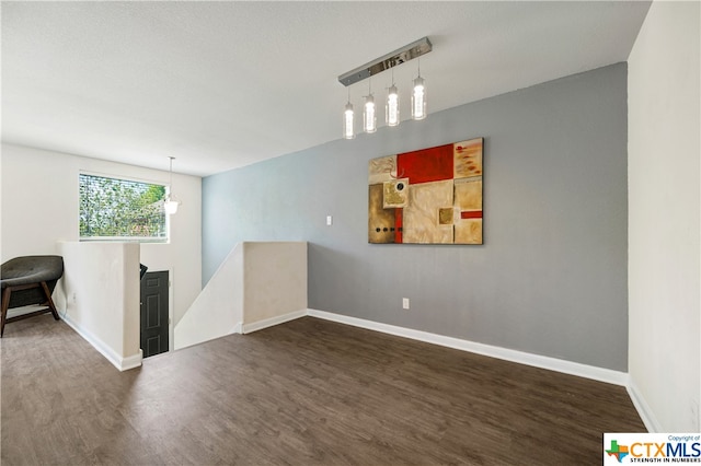 spare room with dark wood-type flooring