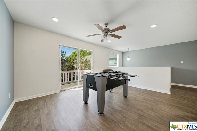 recreation room featuring dark wood-type flooring and ceiling fan