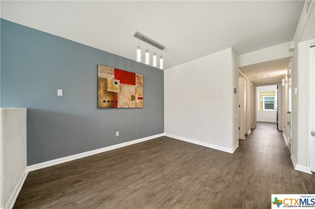 unfurnished room with dark wood-type flooring