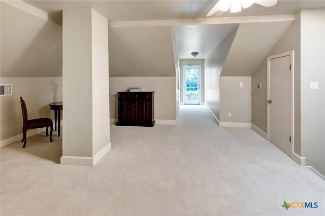 additional living space featuring ceiling fan and light colored carpet