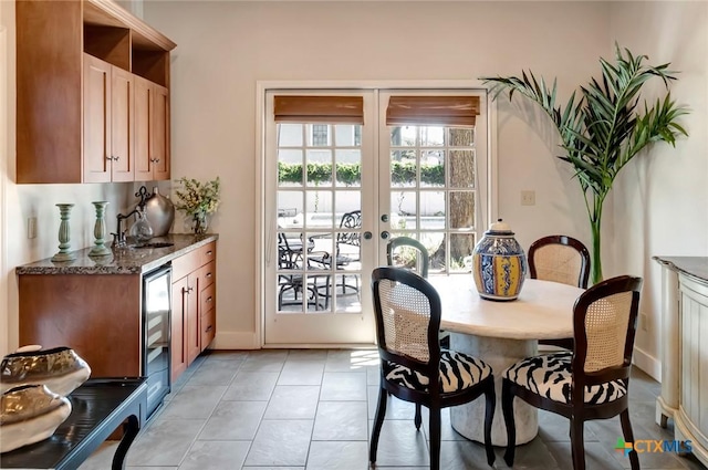 dining area with light tile patterned floors and french doors