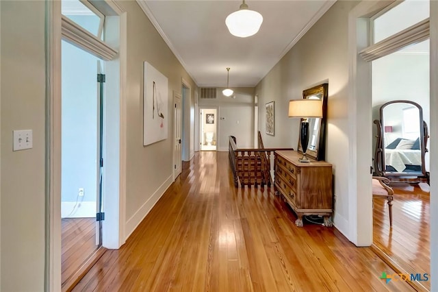 hallway featuring light hardwood / wood-style floors and ornamental molding