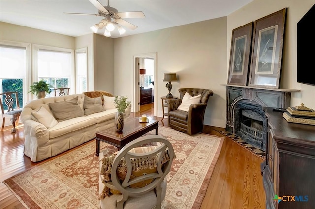 living room featuring ceiling fan and light wood-type flooring