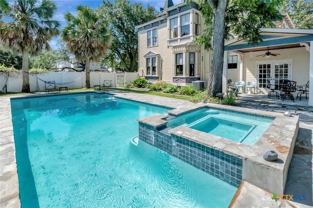 view of swimming pool with central air condition unit, an in ground hot tub, ceiling fan, and a patio