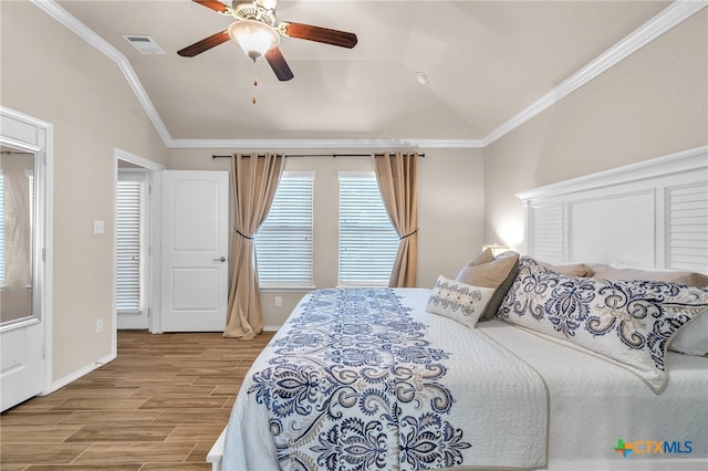 bedroom featuring wood-type flooring, ceiling fan, crown molding, and vaulted ceiling