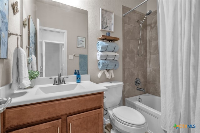 full bathroom featuring vanity, shower / bathtub combination with curtain, and toilet