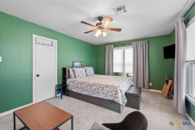4007 Austin Ave, Waco, TX 76710 - bedroom with carpet, a ceiling fan, and a textured wall