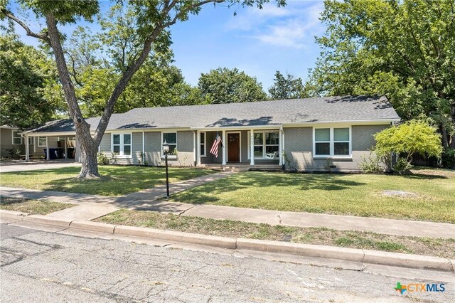 4007 Austin Ave, Waco, TX 76710 - ranch-style home with a front yard, brick siding, and a porch