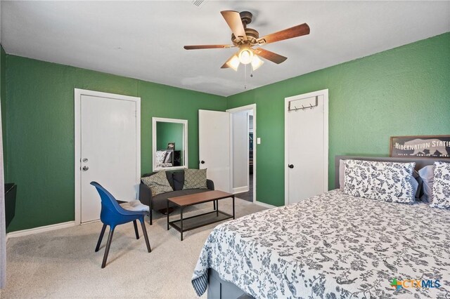 4007 Austin Ave, Waco, TX 76710 - bedroom with light colored carpet, a textured wall, and ceiling fan