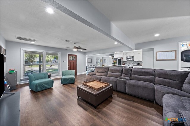 4007 Austin Ave, Waco, TX 76710 - living room featuring dark wood-style floors, recessed lighting, ceiling fan, and stacked washing machine and dryer