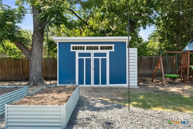 4007 Austin Ave, Waco, TX 76710 - view of shed featuring a fenced backyard and a playground