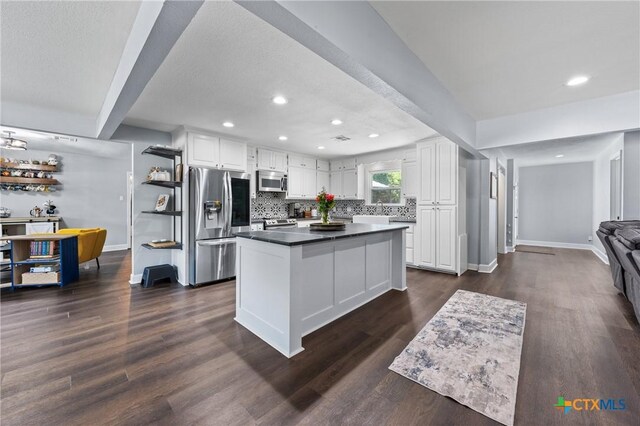 4007 Austin Ave, Waco, TX 76710 - kitchen featuring stainless steel appliances, white cabinets, dark countertops, recessed lighting, and decorative backsplash