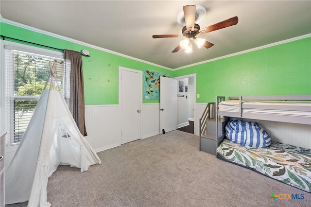 4007 Austin Ave, Waco, TX 76710 - carpeted bedroom with ornamental molding, a wainscoted wall, and a ceiling fan