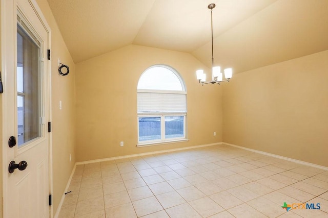 empty room featuring light tile patterned floors, vaulted ceiling, and an inviting chandelier