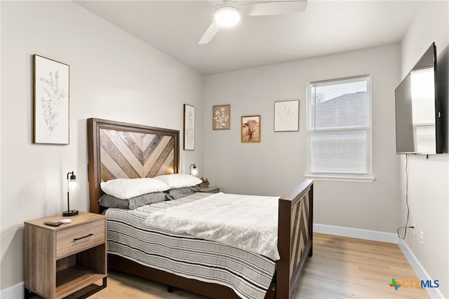 bedroom with ceiling fan and light wood-type flooring