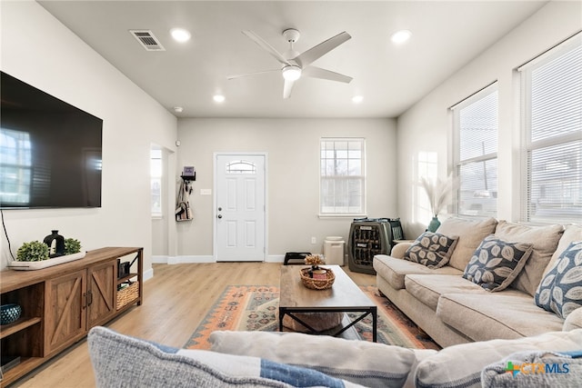 living room featuring ceiling fan and light wood-type flooring