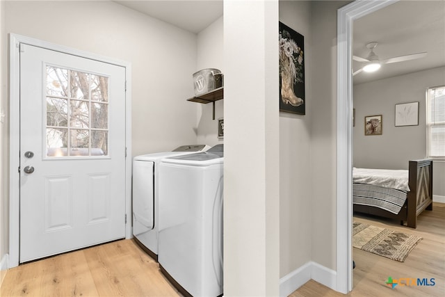 laundry room with light hardwood / wood-style floors, washer and clothes dryer, and ceiling fan