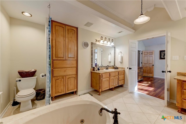 bathroom featuring a bath, crown molding, hardwood / wood-style floors, toilet, and vanity