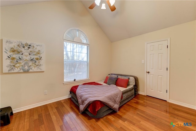 bedroom featuring ceiling fan, high vaulted ceiling, and wood-type flooring