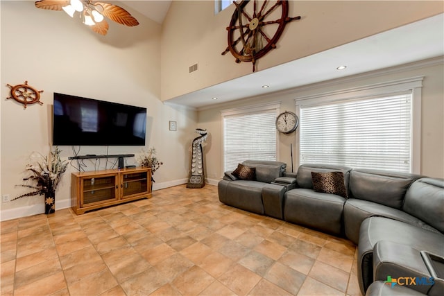 living room with ceiling fan, high vaulted ceiling, and ornamental molding