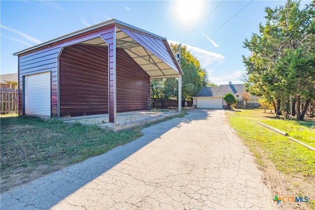 view of outdoor structure with a lawn and a garage