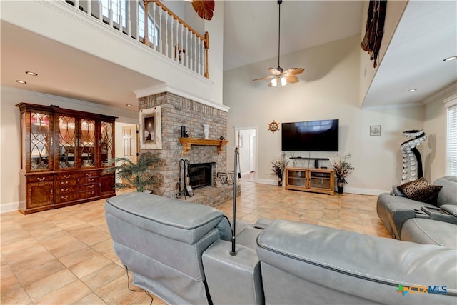 tiled living room featuring a towering ceiling, a brick fireplace, ceiling fan, and crown molding