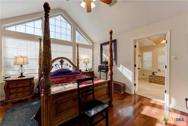 bedroom with hardwood / wood-style flooring, ensuite bath, multiple windows, and lofted ceiling