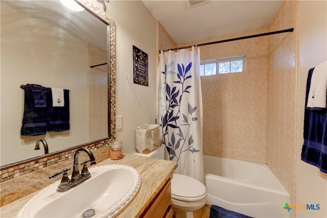 full bathroom featuring vanity, tasteful backsplash, toilet, and shower / bathtub combination with curtain