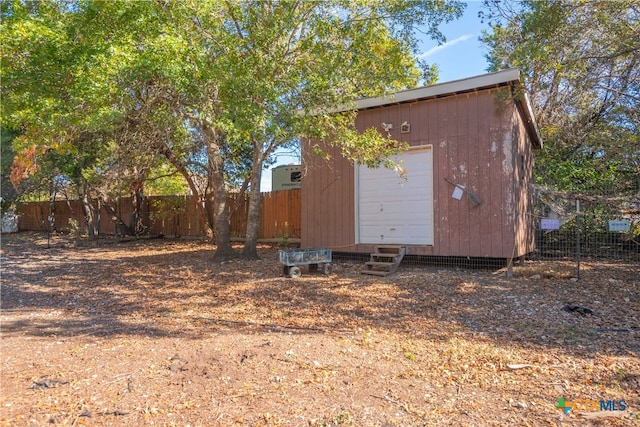 view of side of home featuring an outdoor structure