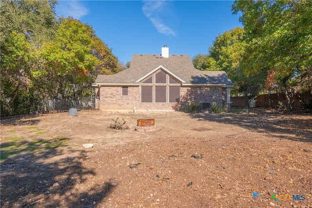 back of house featuring a fire pit